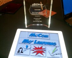 aNm's Creativity shines through in our award winning, "MoCom Mo' Learning" mobile interaction - a rudimentary application that provides digital comic book reader functionality with animated onscreen elements. Photograph of the DemoFest Award for Best in Show Award next to the MoCom Mo' Learning app on a digital tablet.